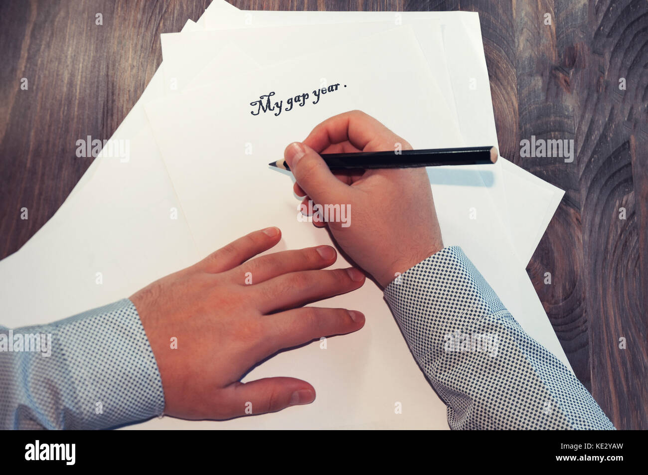 A sheet of paper in front of a man with the words: My gap year . Planning of affairs for the year. The concept. Stock Photo