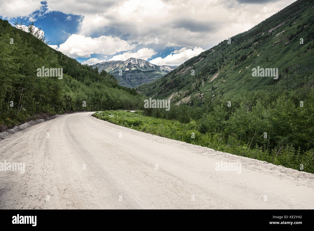 Empty dirt road leading to the mountains, Rocky Mountains, Colorado, USA Stock Photo