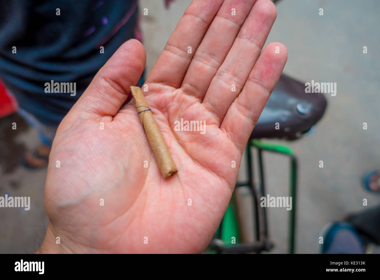 Delhi, India September 25, 2017 Close up of a hand of a man with a leaf wrapped cigarette