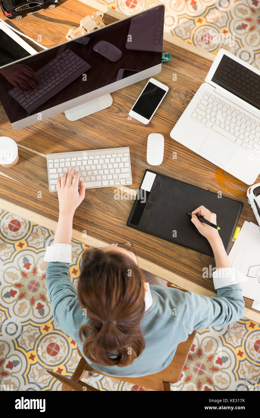 High angle view of young female car designer at work Stock Photo - Alamy