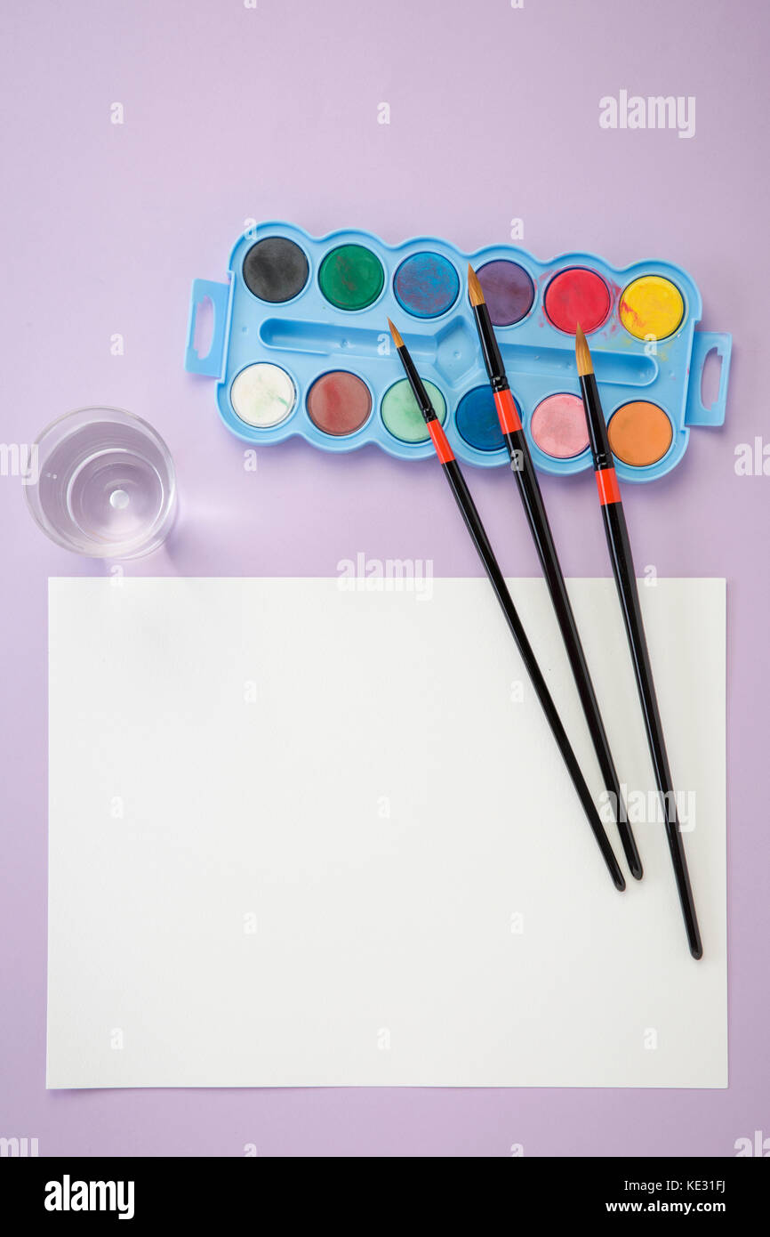 Art materials such as brushes, paper and palette Stock Photo