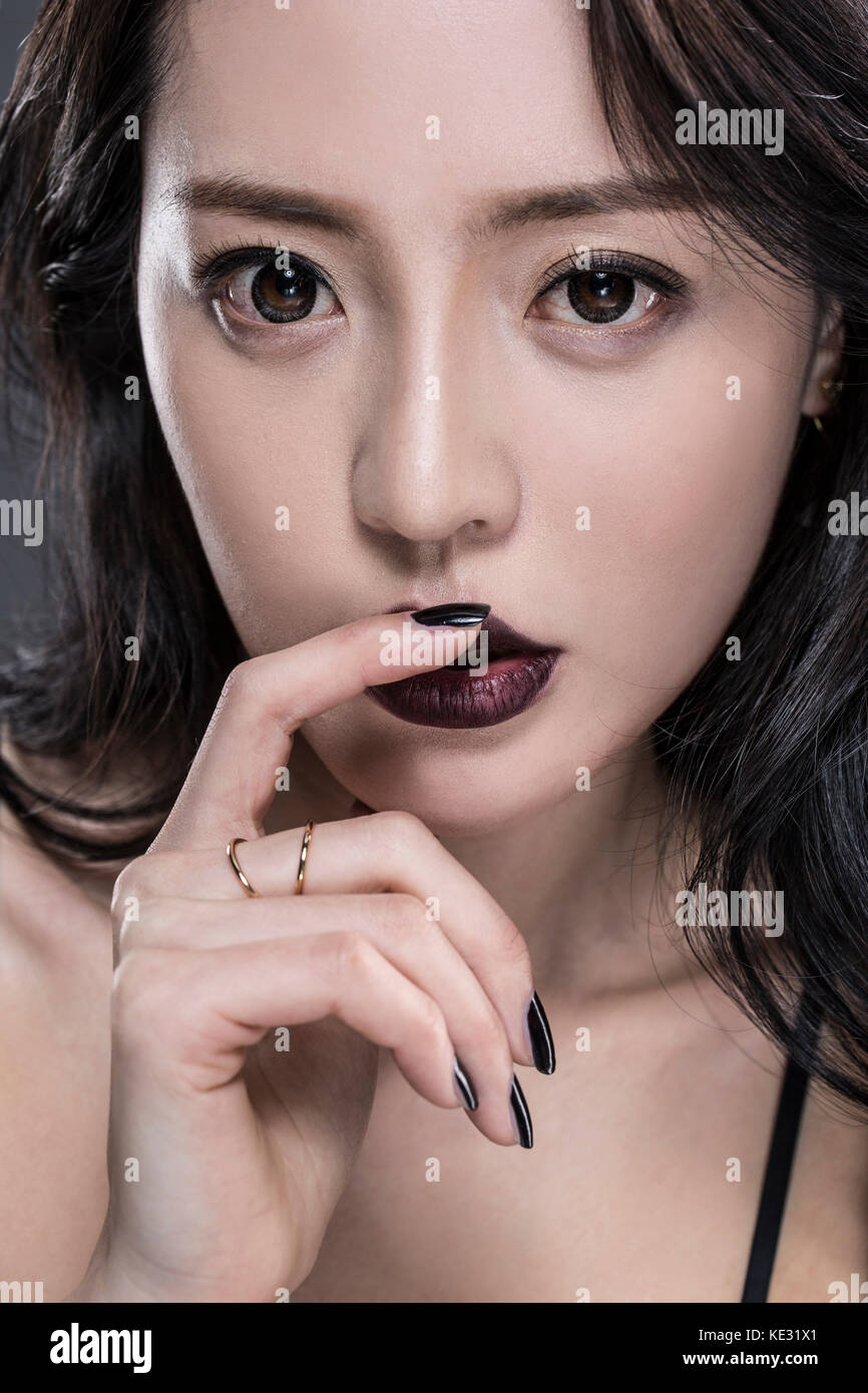 Portrait of young woman touching her lips Stock Photo Alamy