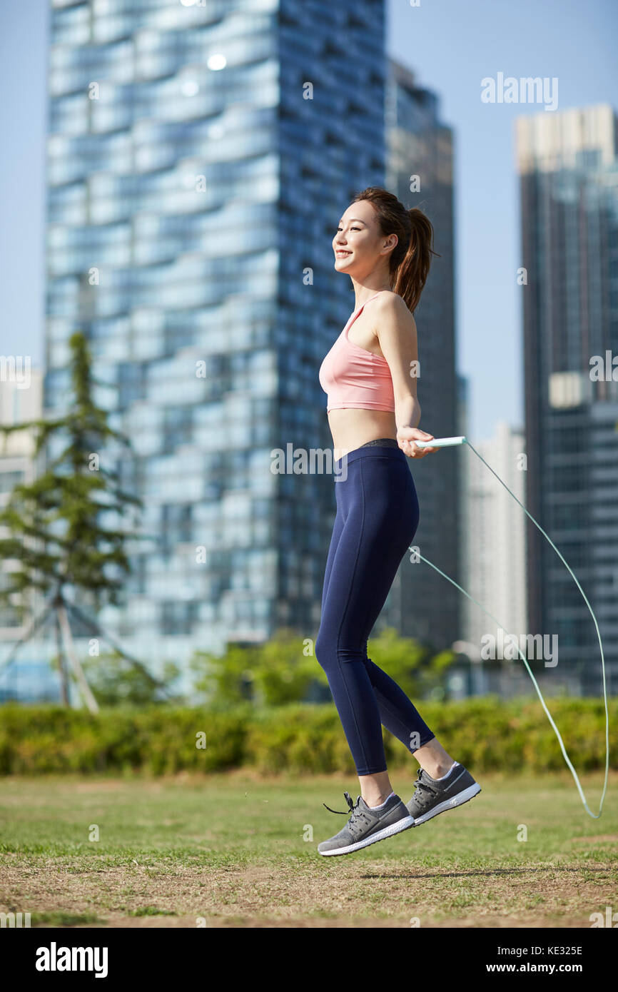 Skip Rope Side View Side view of young smiling slim woman exercising with jump rope Stock ...