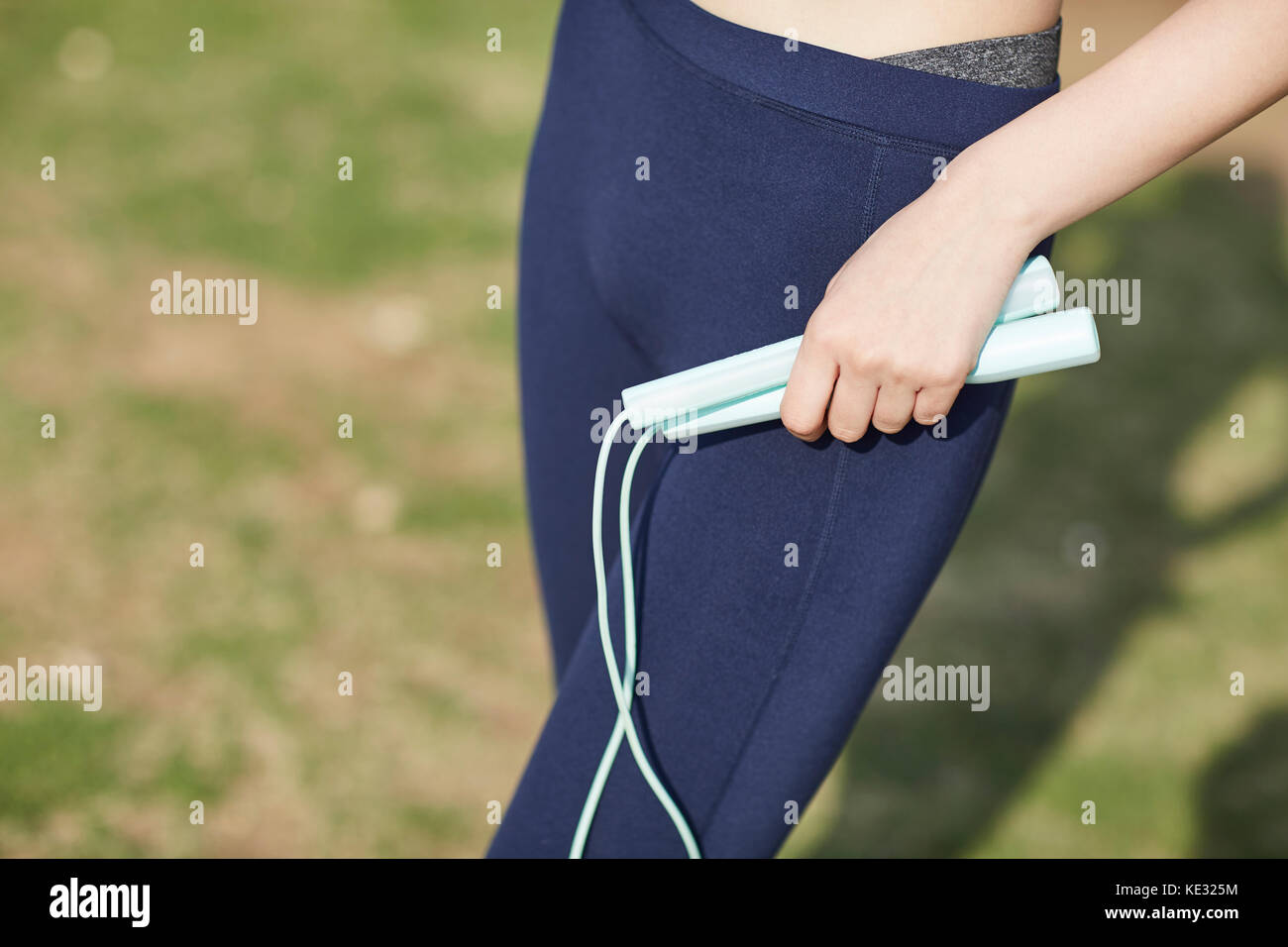 Woman with jump rope Stock Photo - Alamy