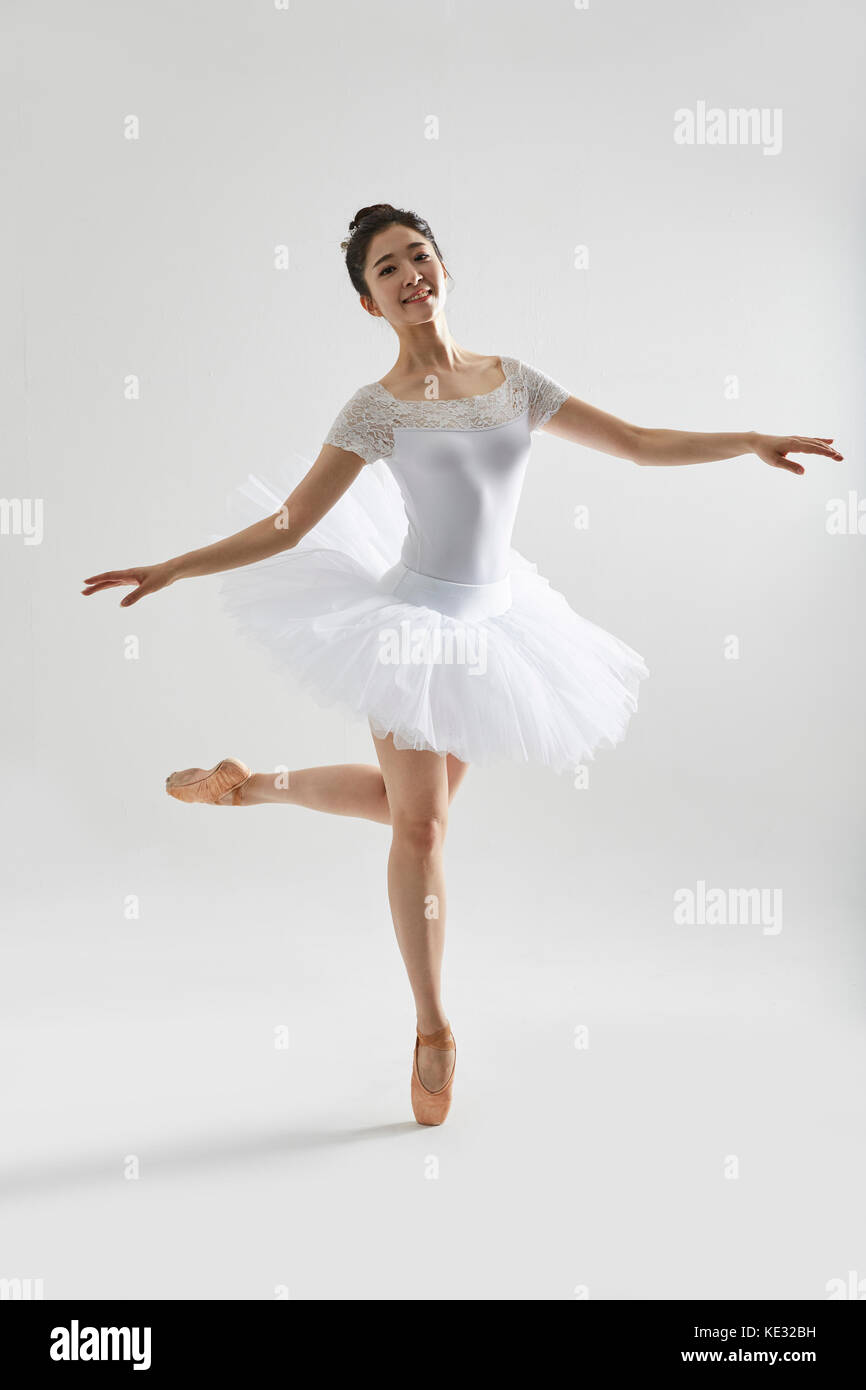 Young smiling woman in ballet clothes posing elegantly Stock Photo - Alamy