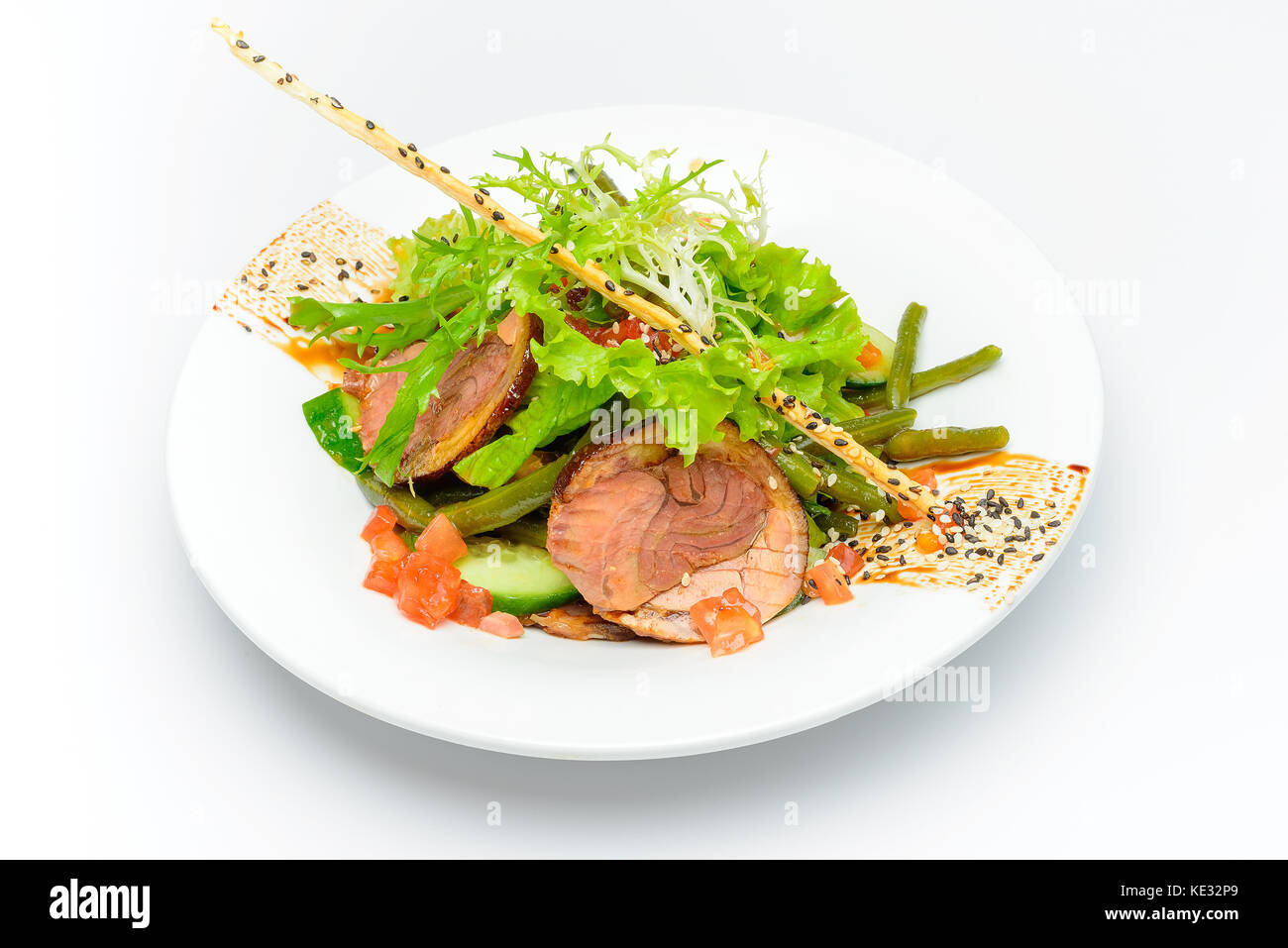 Fresh cut meat slices decorated witn salad, cucumber, tomatoes Stock Photo