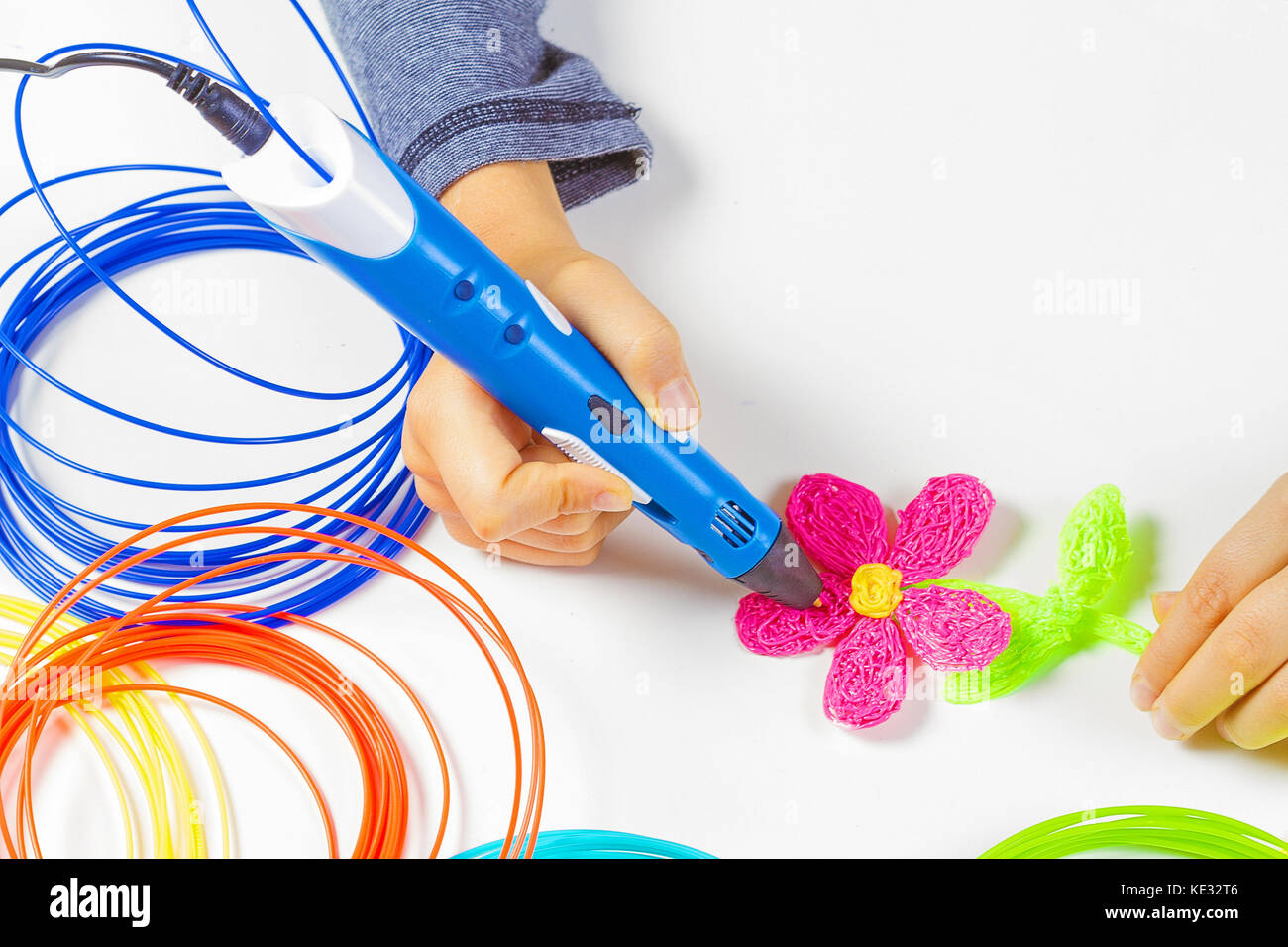 Kid hand holding blue 3d printing pen and making new item Stock Photo ...