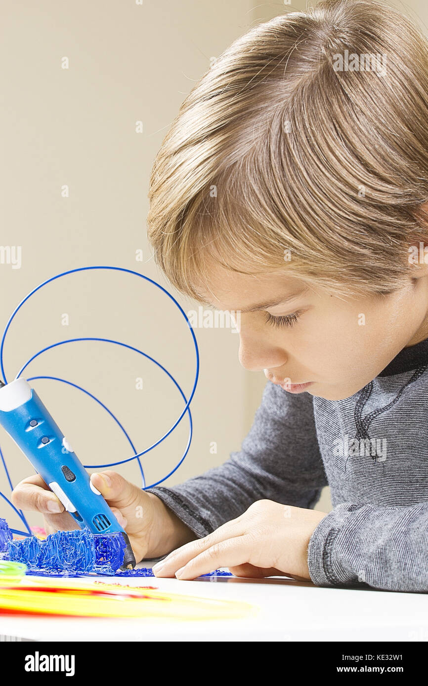 Focused child creating with 3d printing pen Stock Photo - Alamy