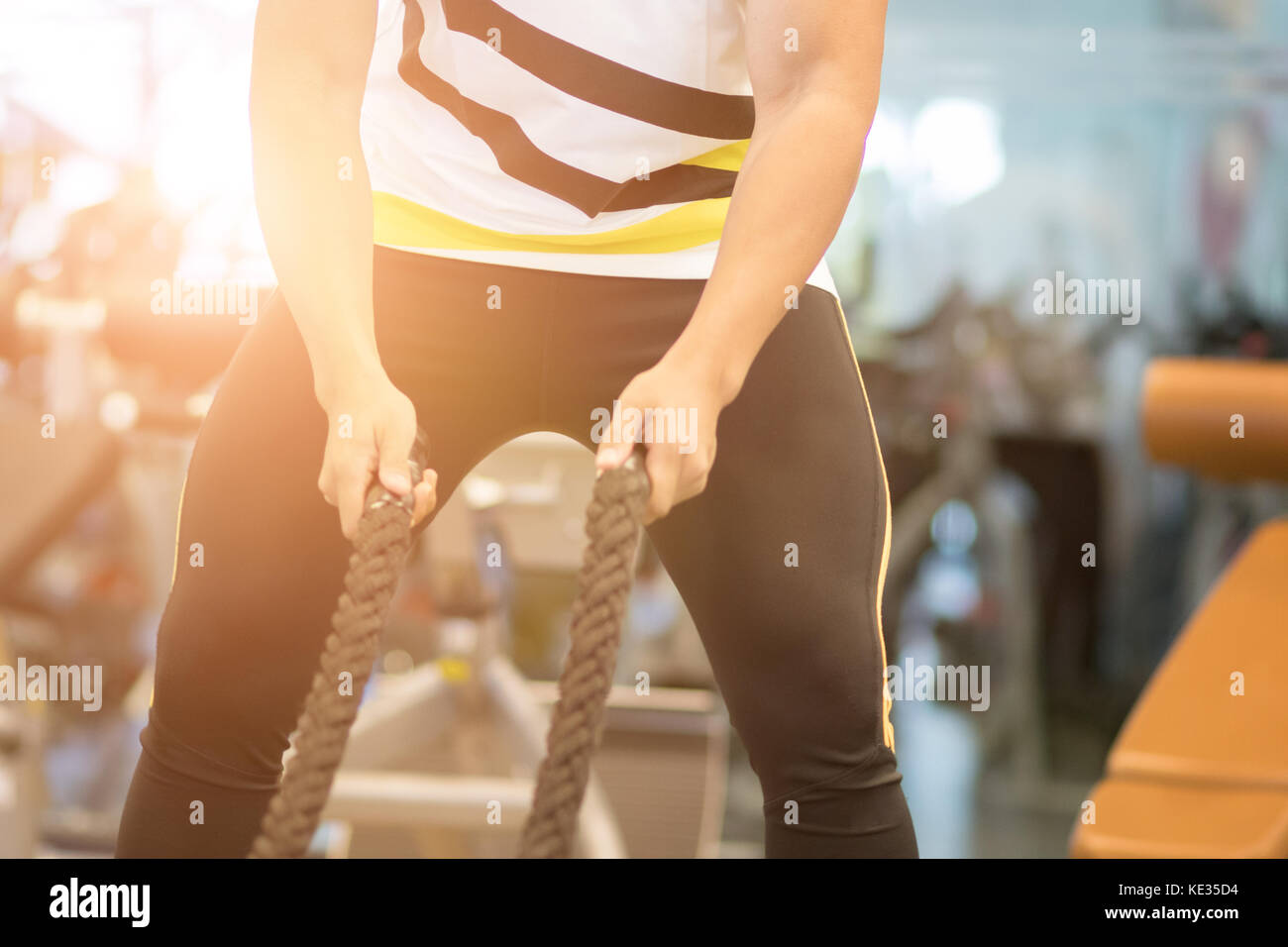 Execute Rope young man execute exercise in fitness center. male athlete training ...