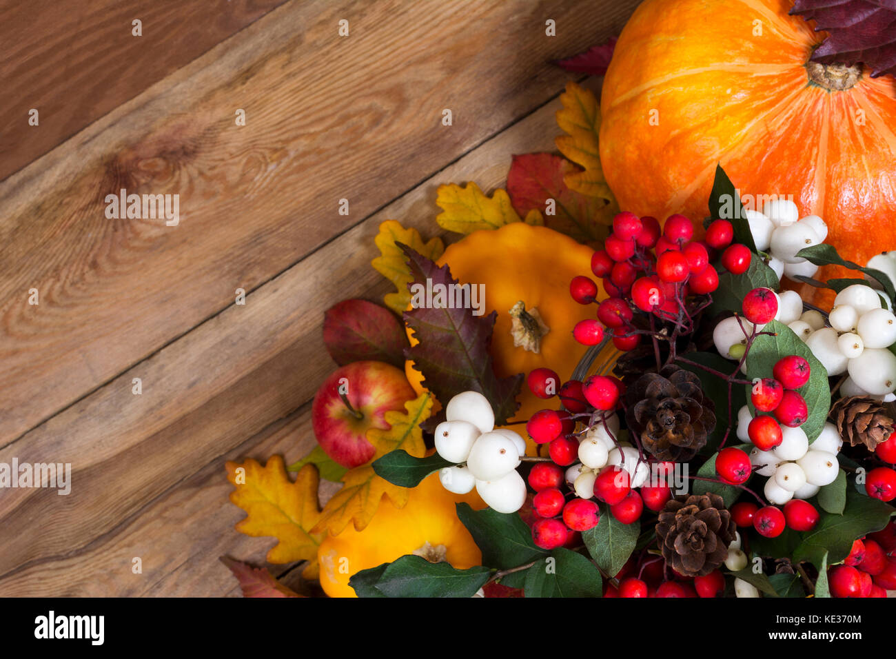 Thanksgiving background with ghostberry, rowan berries, cones, pumpkin ...