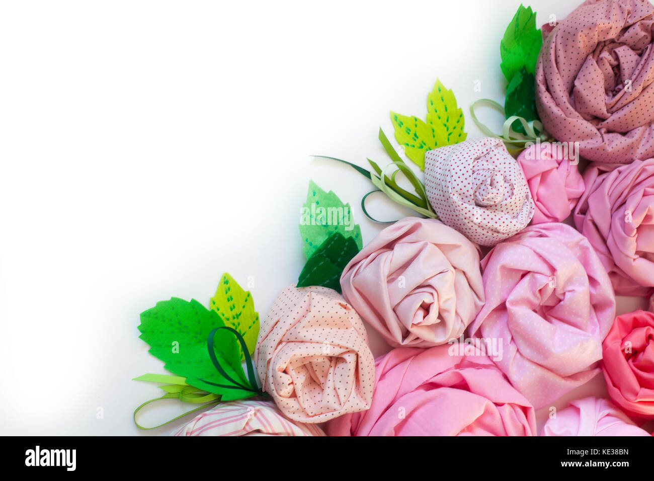 Rose of pink fabric. White background. Flowers of the cotton fabric
