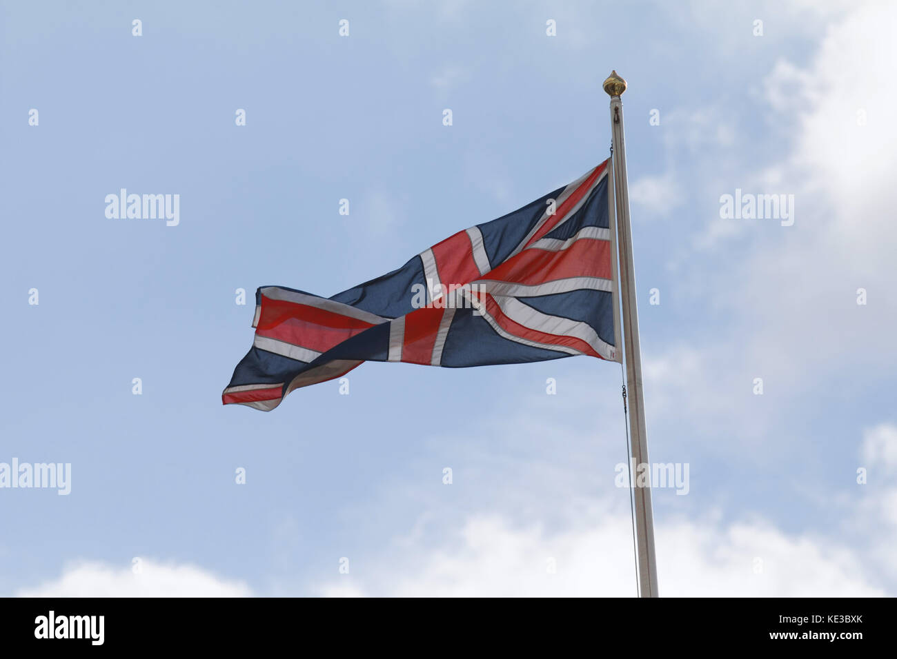 British union jack flag on the wind in front blue sky Stock Photo - Alamy