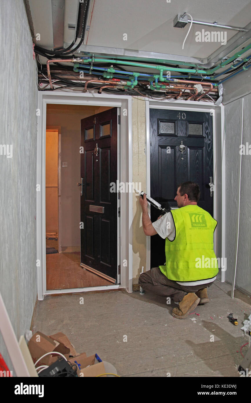 Workmen Installing New Fire Doors During The Refurbishment