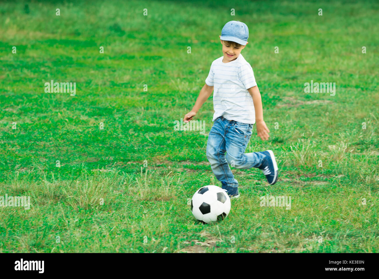 Happy Boy Playing With Soccer Ball In The Park Stock Photo Alamy