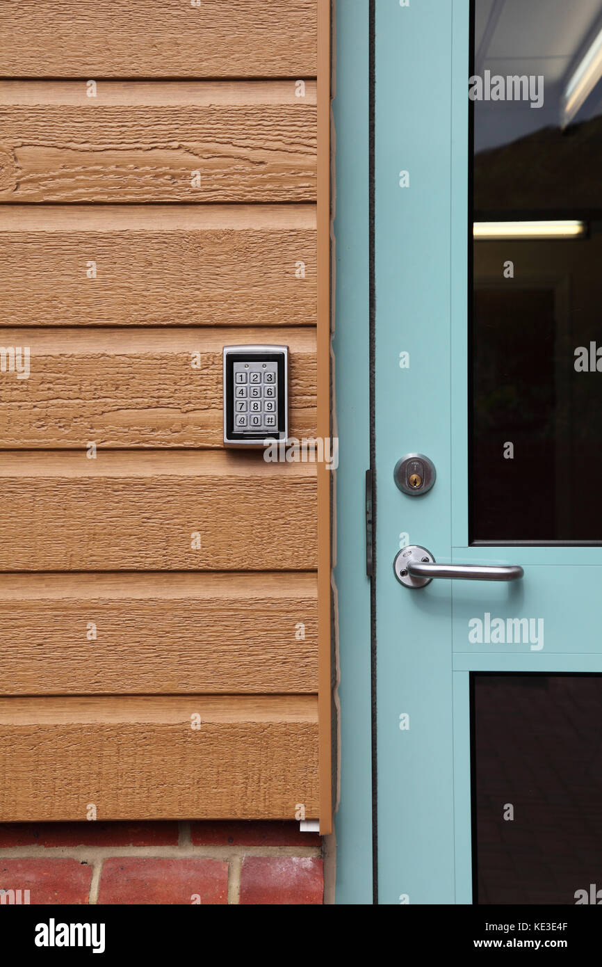 Digital code entry pad at the entrance to a modern care home for the elderly. Mounted on plastic, wood-effect cladding. Stock Photo