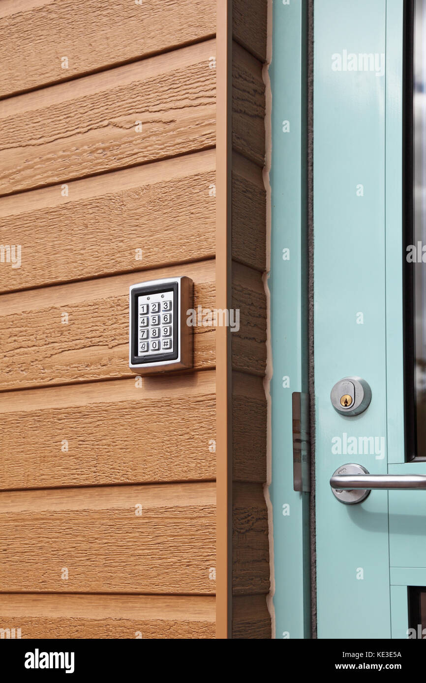 Digital code entry pad at the entrance to a modern care home for the elderly. Mounted on plastic, wood-effect cladding. Stock Photo