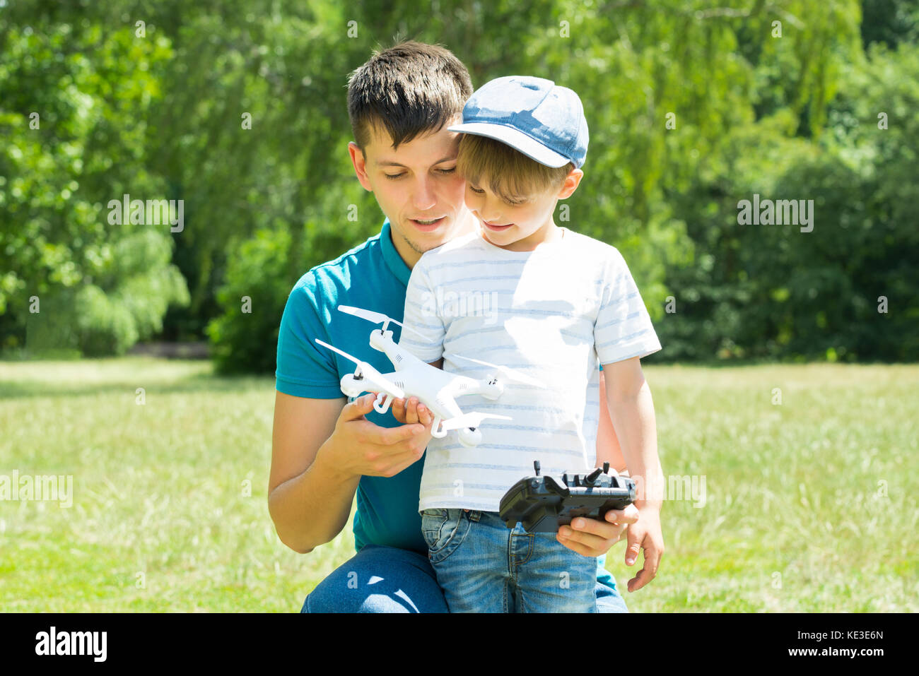 Father And Son Playing With The White Drone In The Park Stock Photo - Alamy