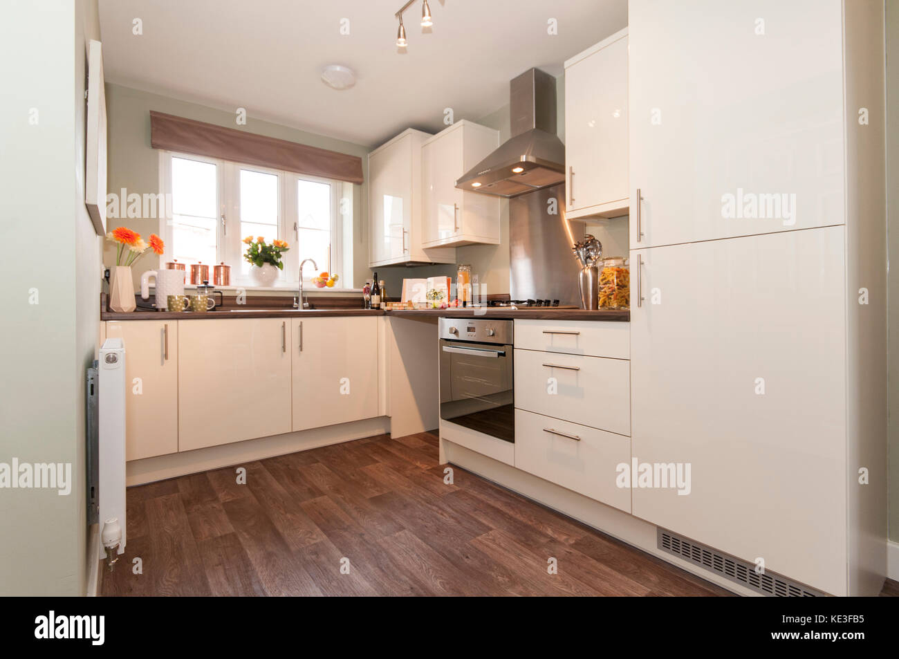 Wide Shot Of Newly Fitted Kitchen With Cream Cupboards Stock Photo