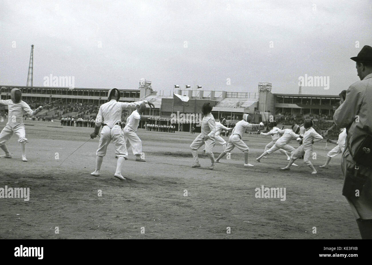 1938. historical, male competitiors fencing in the centre of the giant Strahov Stadium, Prague, Czechoslovakia at the Pan-Sokol International Slet festival. The sokol movement flourished in the interwar period. Stock Photo