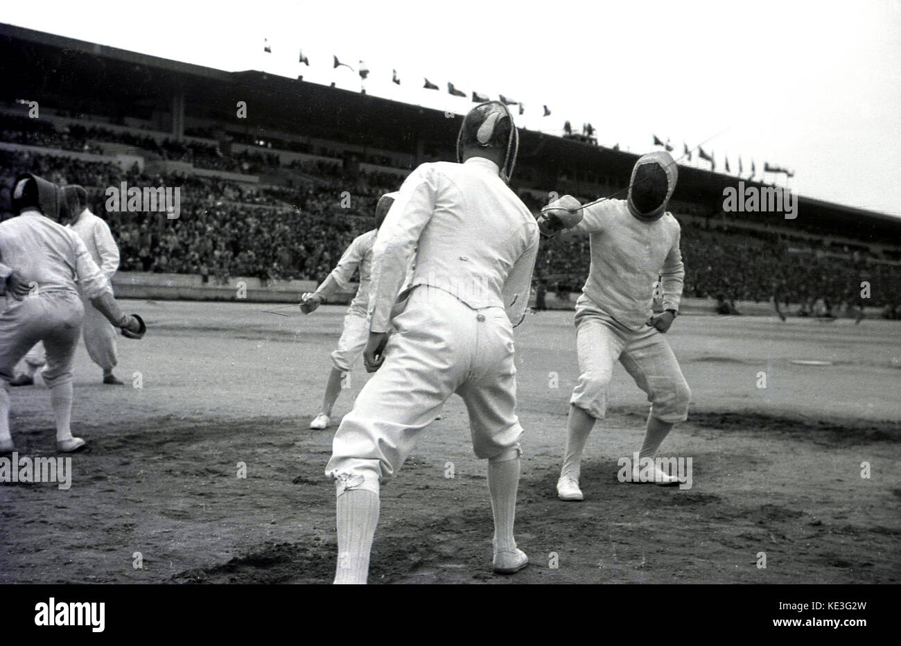 1938. historical, male competitiors fencing in the centre of the giant Strahov Stadium, Prague, Czechoslovakia at the Pan-Sokol International Slet festival. The sokol movement flourished in the interwar period. Stock Photo