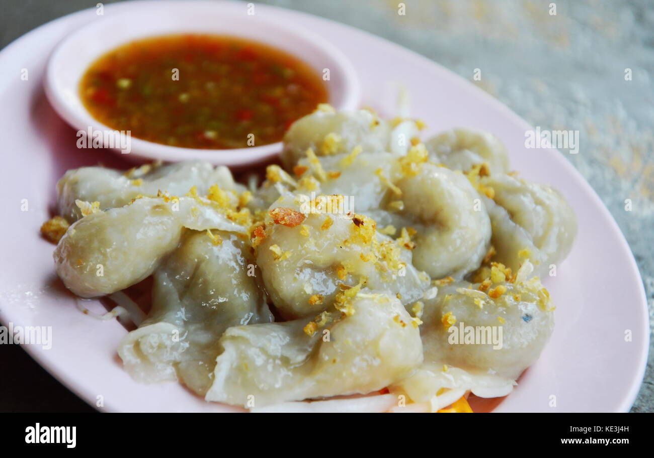 fish dumpling dipping spicy sauce on plate Stock Photo Alamy
