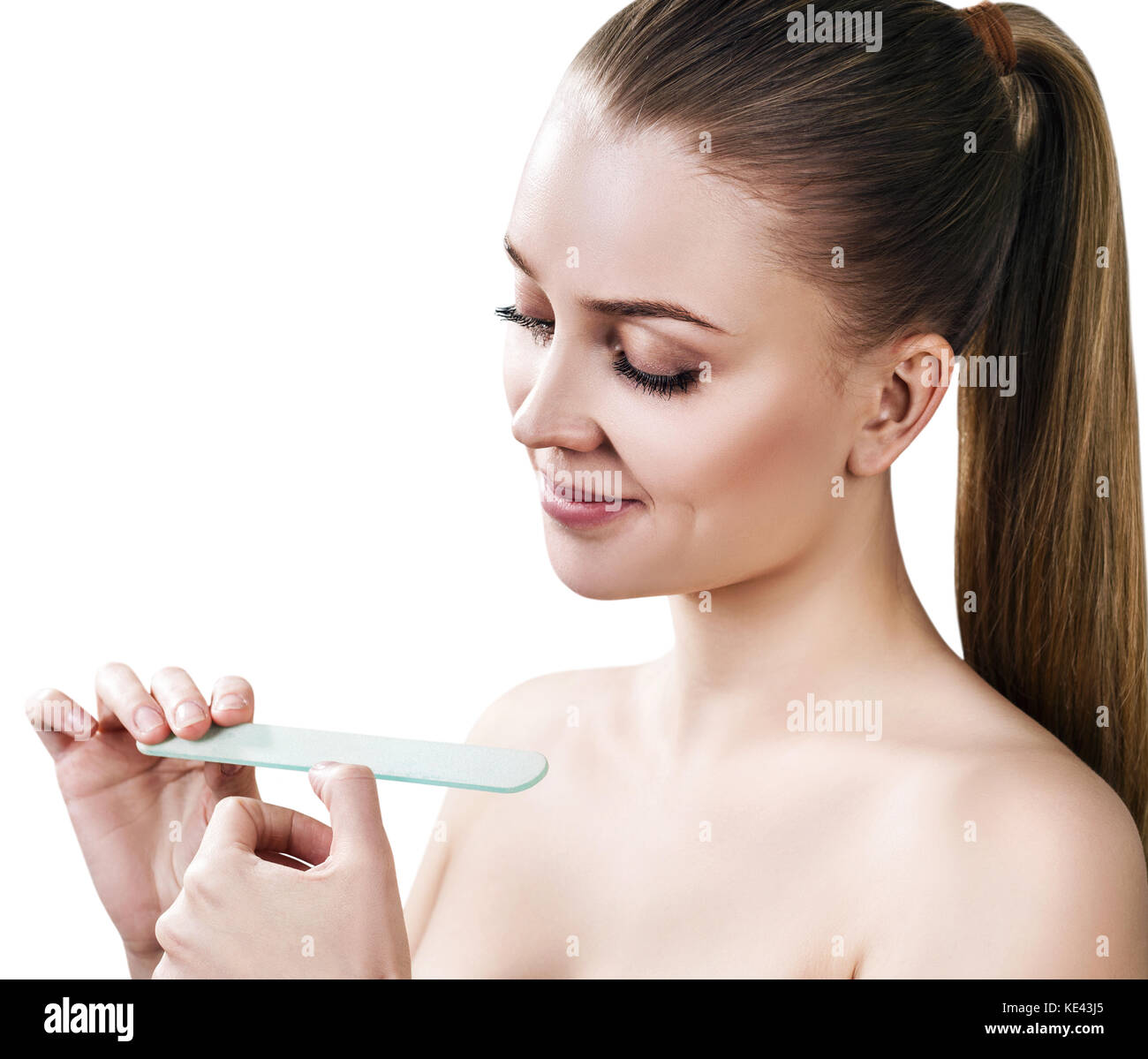 Young woman doing manicure with nail file. Stock Photo