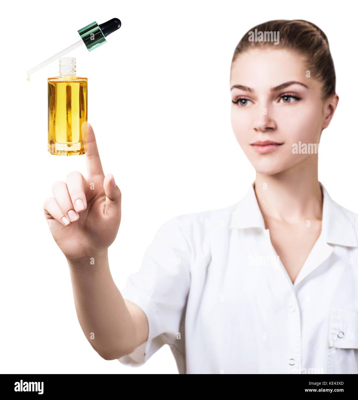 Young cosmetologist woman presents cosmetics oil. Stock Photo