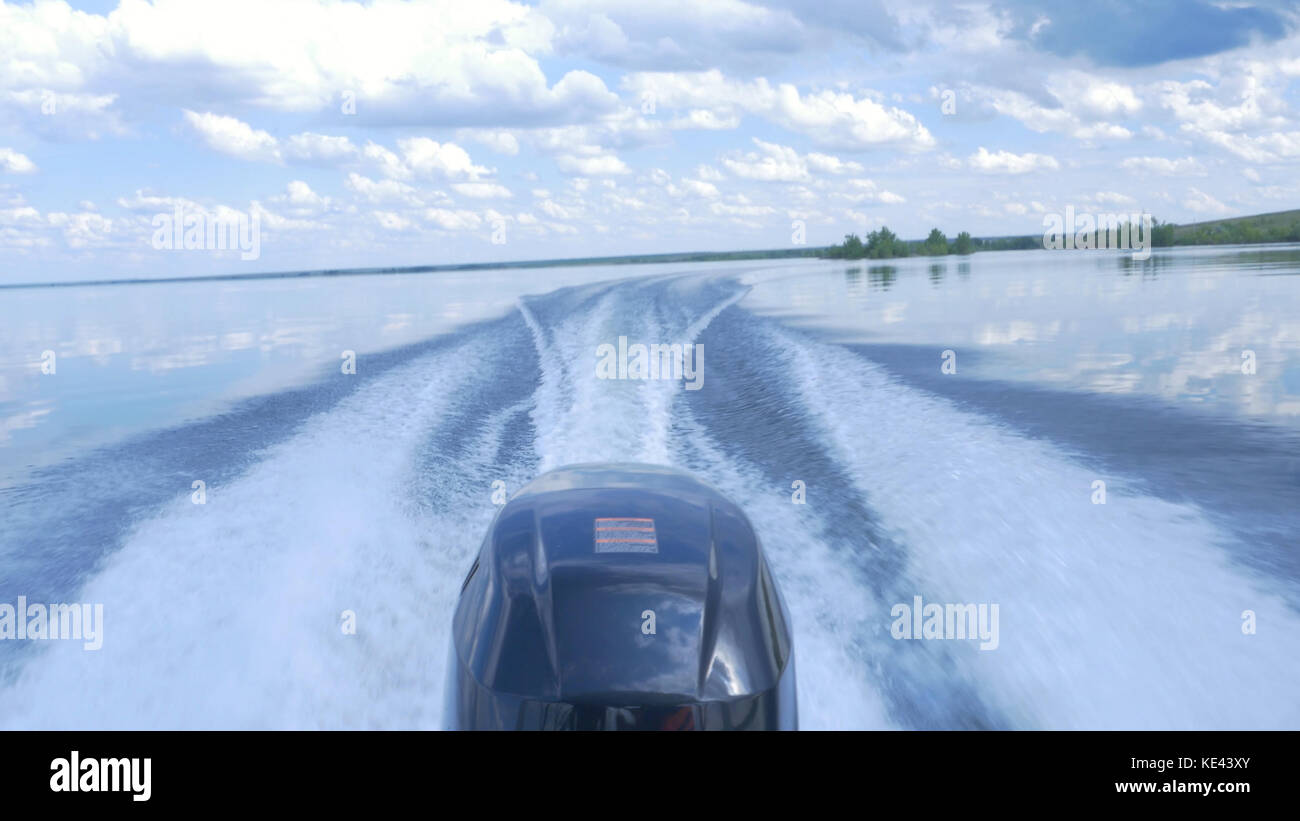 Trail on water surface behind of fast moving motor boat. the motor of ...
