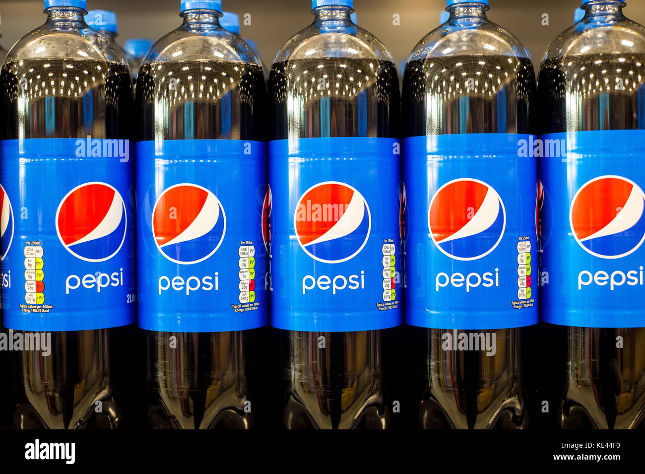 Bottles of Pepsi Cola stacked own the shelf in a UK Supermarket Stock