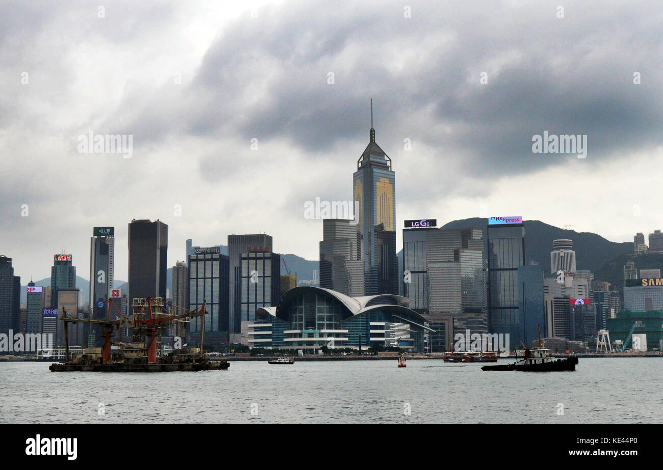 A tugboat in Victoria harbor with the Wan Chai district in the background. Stock Photo