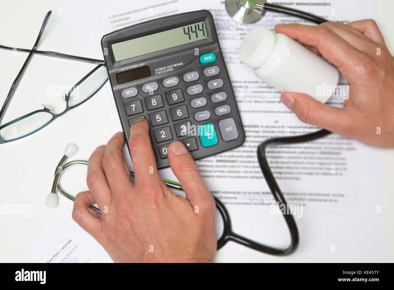 Healthcare costs and fees concept.Hand of smart doctor used a calculator  for medical costs in modern hospital with VR icon diagram Stock Photo -  Alamy