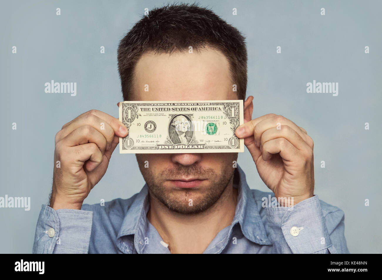 A Man Holds A U S 1 One Dollar The Guy Holds Up A One Dollar Bill Before My Eyes See Through Money Hiding Behind Money Verification Of Bills Stock Photo Alamy