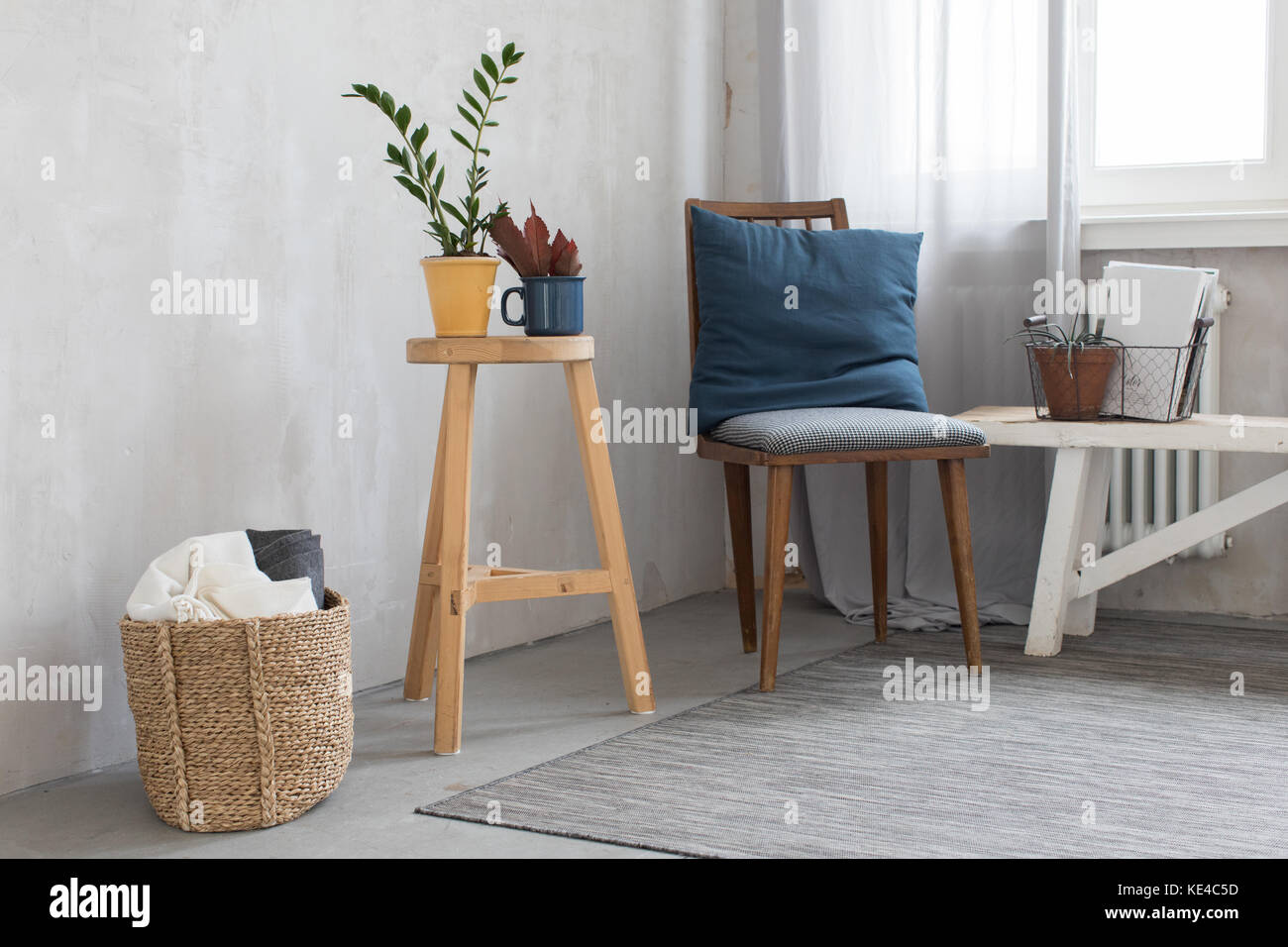 Cute interior with chair against the gray wall Stock Photo