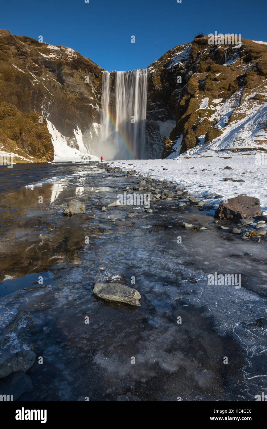 The Skógafoss waterfall is one of the biggest waterfalls in the country with a width of 25 metres (82 feet) and a drop of 60 m (200 ft). Stock Photo