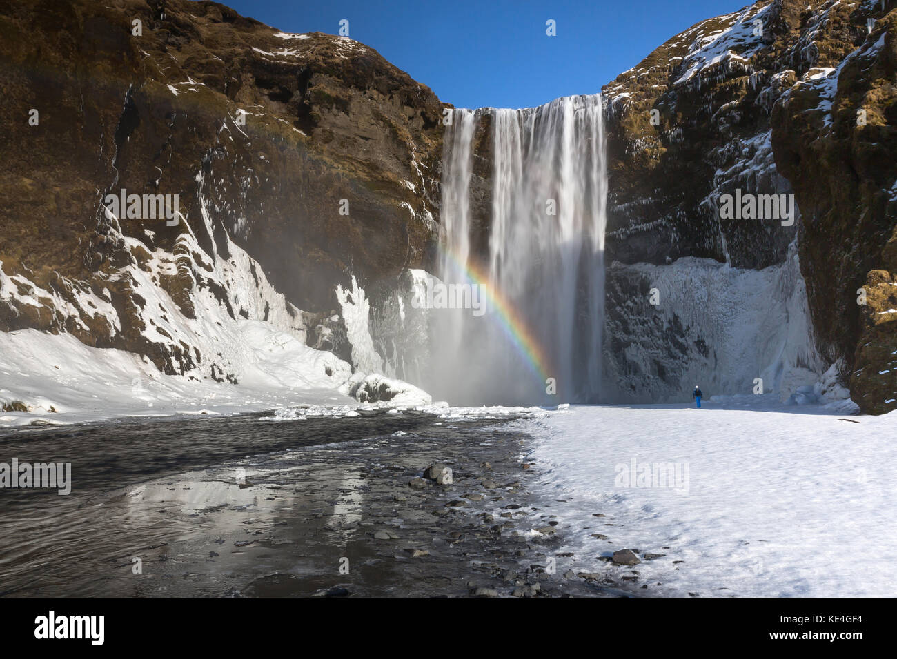 The Skógafoss waterfall is one of the biggest waterfalls in the country with a width of 25 metres (82 feet) and a drop of 60 m (200 ft). Stock Photo