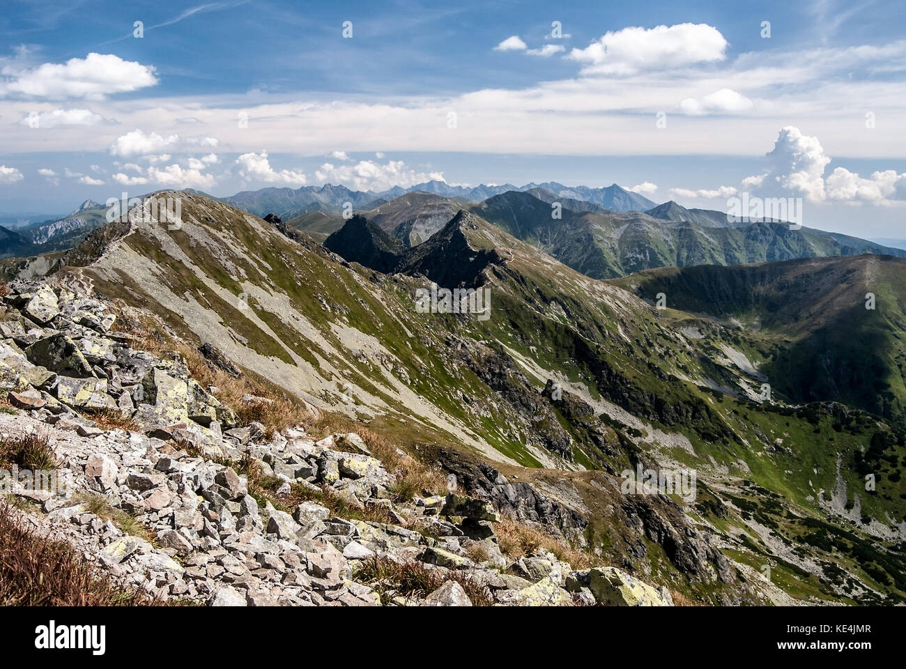 spectacular panorama of Tatras mountain range from Banikov peak in Rohace mountain group in Slovakia during nice day with blue sky and clouds Stock Photo