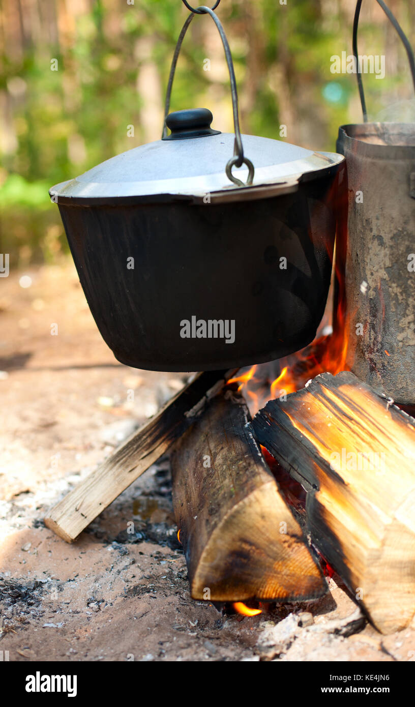 Camping kettles over burning campfire Stock Photo Alamy