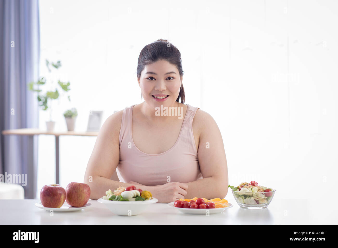 Portrait of young smiling woman with fruits and vegetables Stock Photo ...