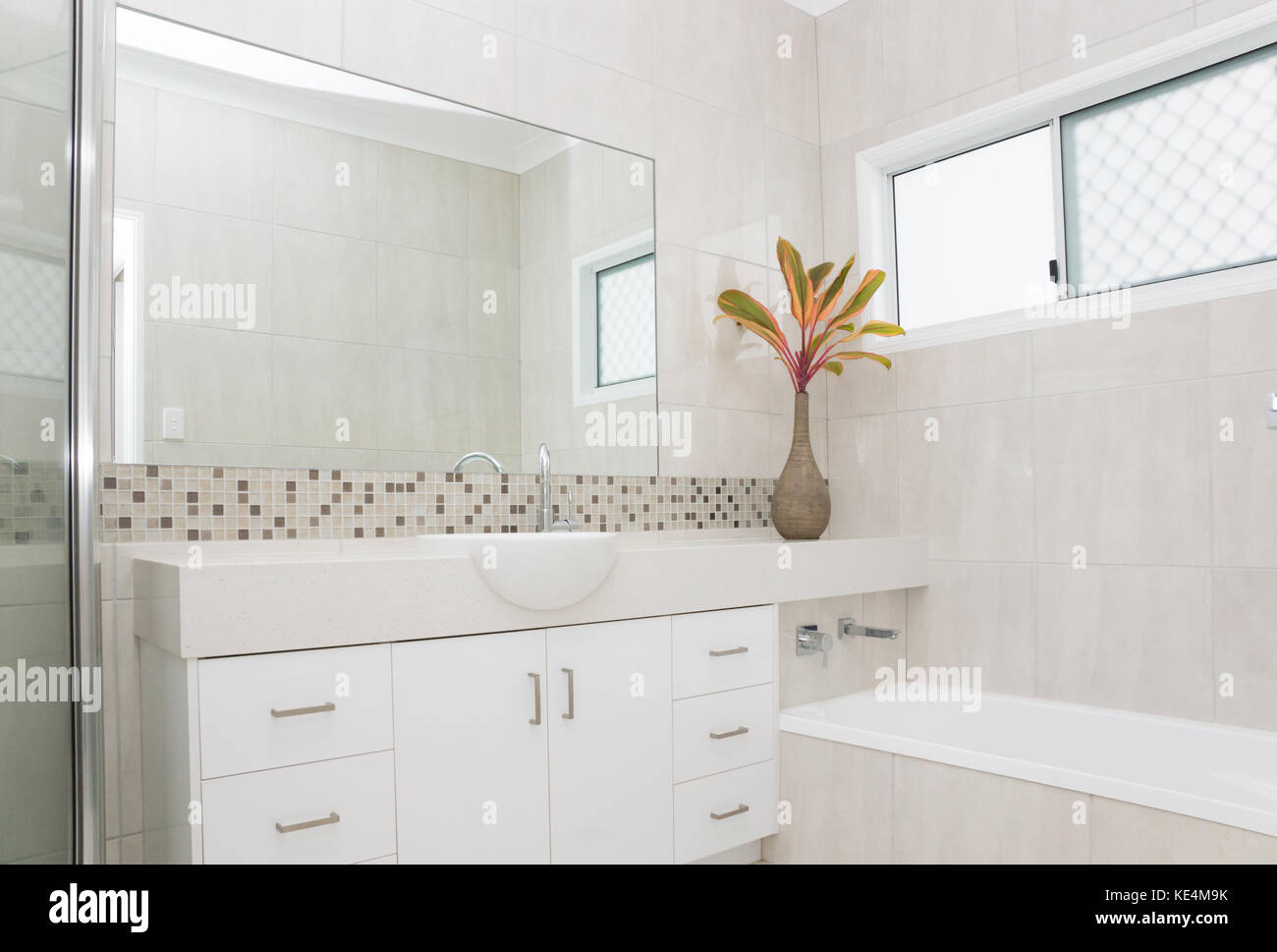 Modern bathroom with granite bench and tiled walls Stock Photo