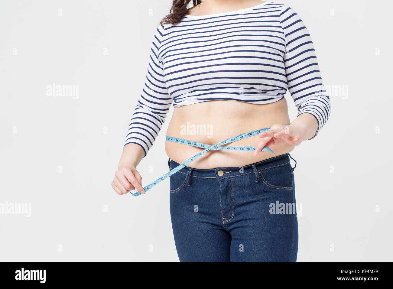 Woman Excess Weight Make Waist Tape Measure Warm Tones Studio Stock Photo  by ©kazzakova 599135156