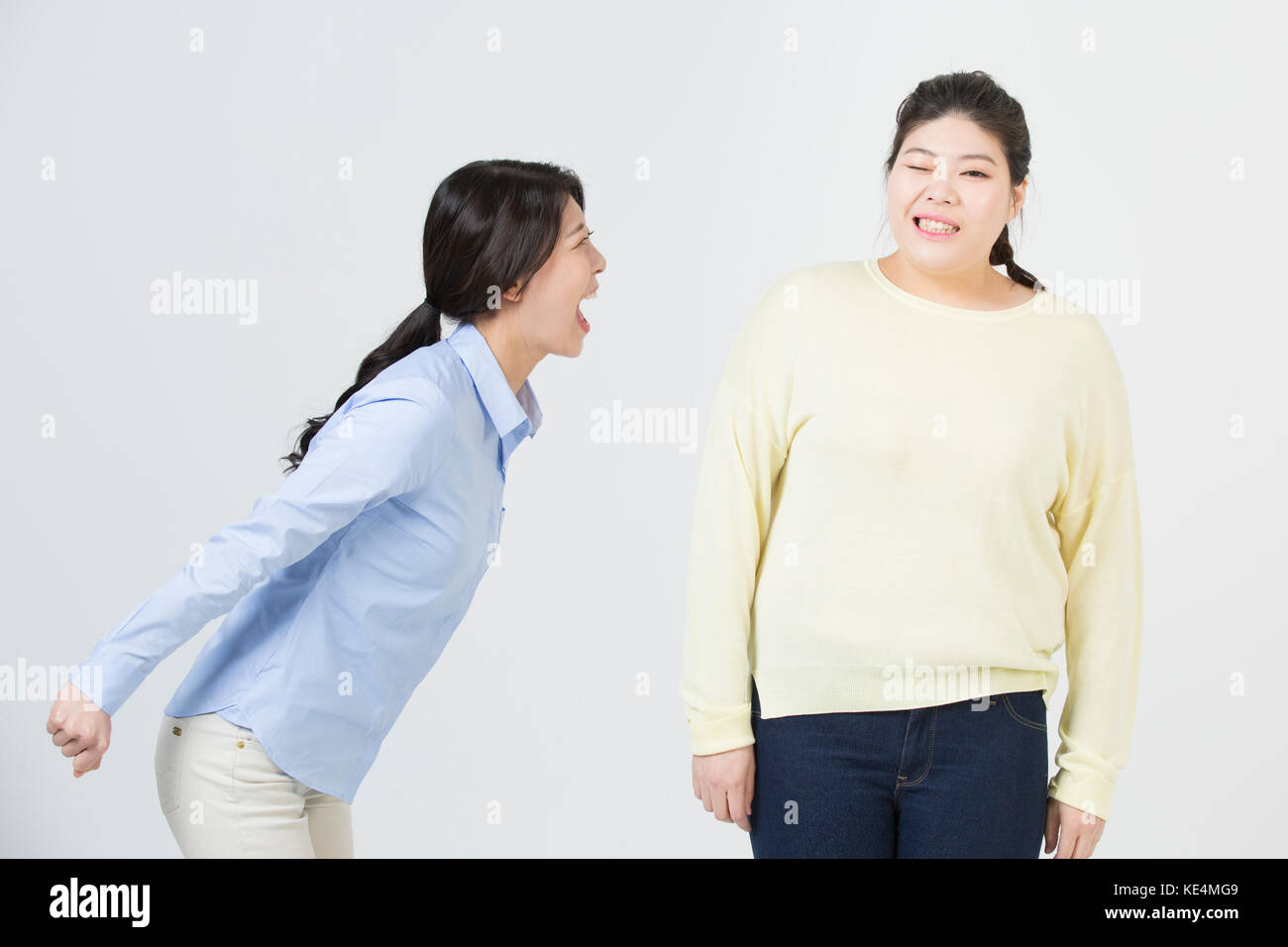 Contrast of young slim woman and young fat woman Stock Photo