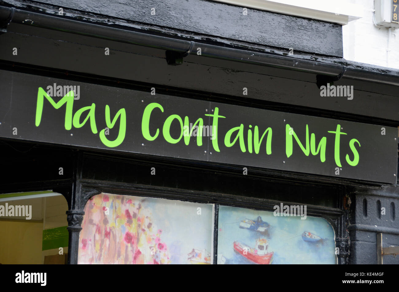 ’May Contain Nuts’ sign above a shop. Stock Photo