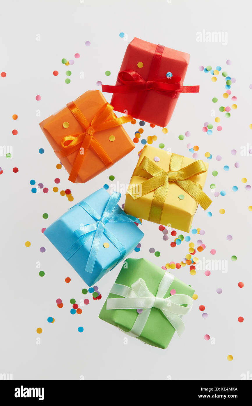 Colorful gift boxes with confetti falling or flying in motion Stock