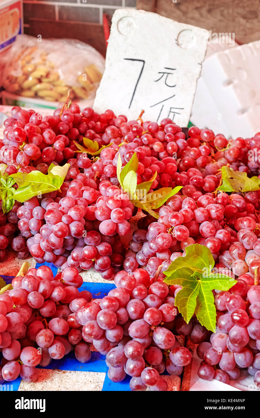 Grapes sale on a local fruit market, selective focus, China Stock Photo