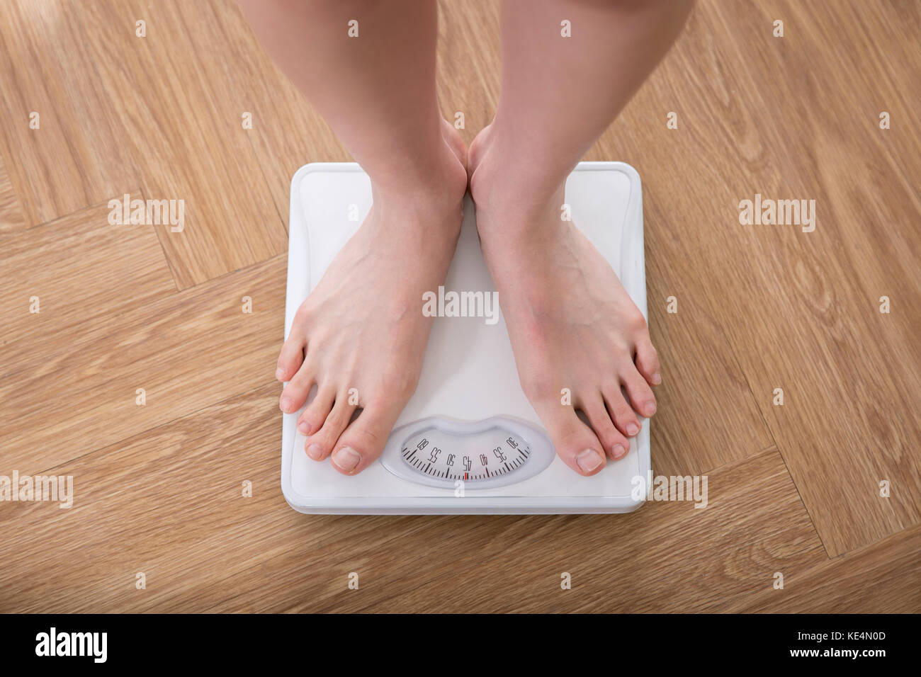Woman standing on a scale stock photo alamy