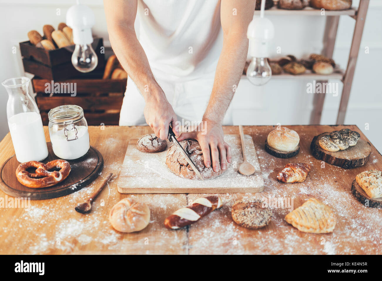 Baker with a variety of healthy and delicious freshly baked bread and