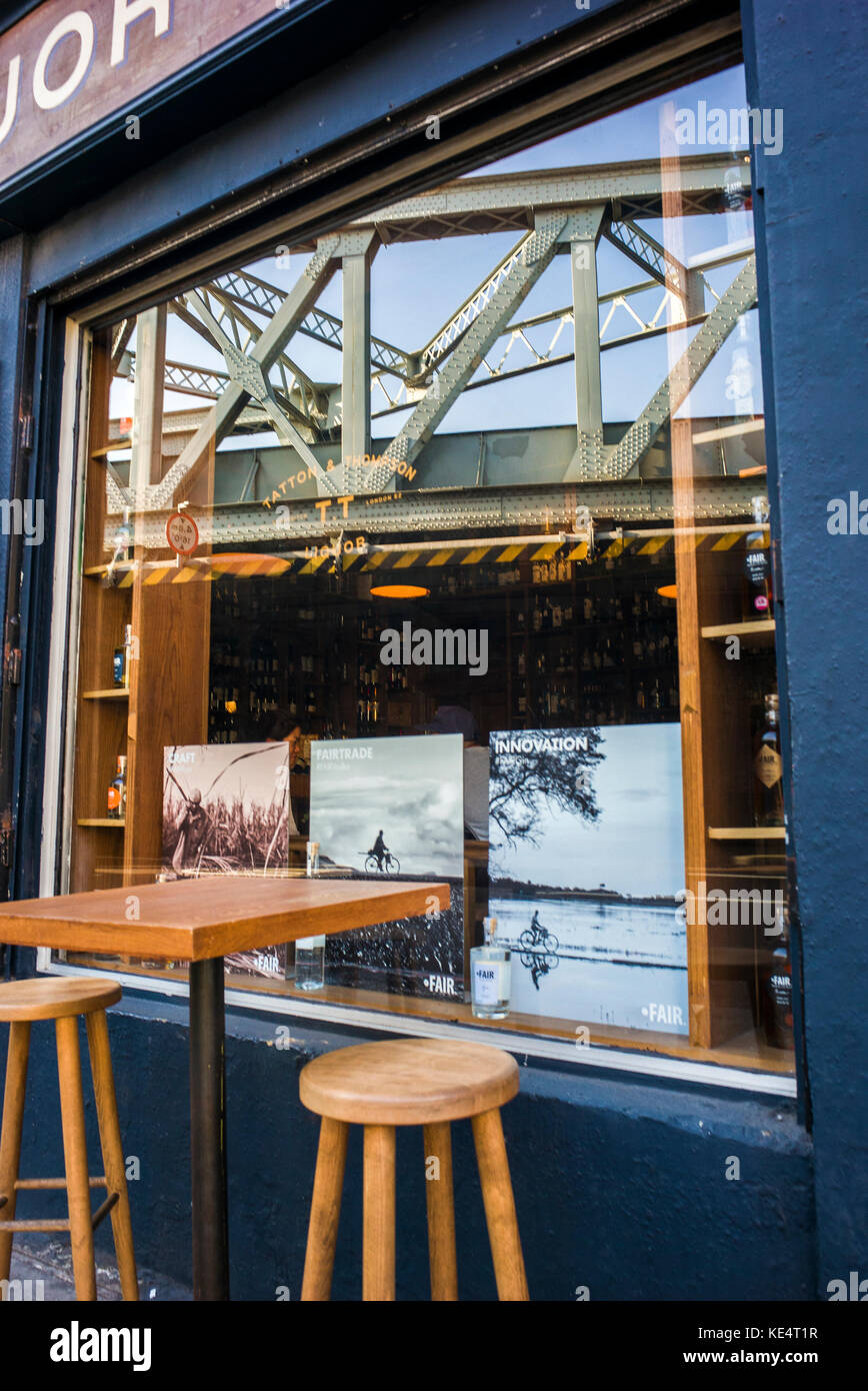 reflection in coffee shop window of victorial railway bridge Stock
