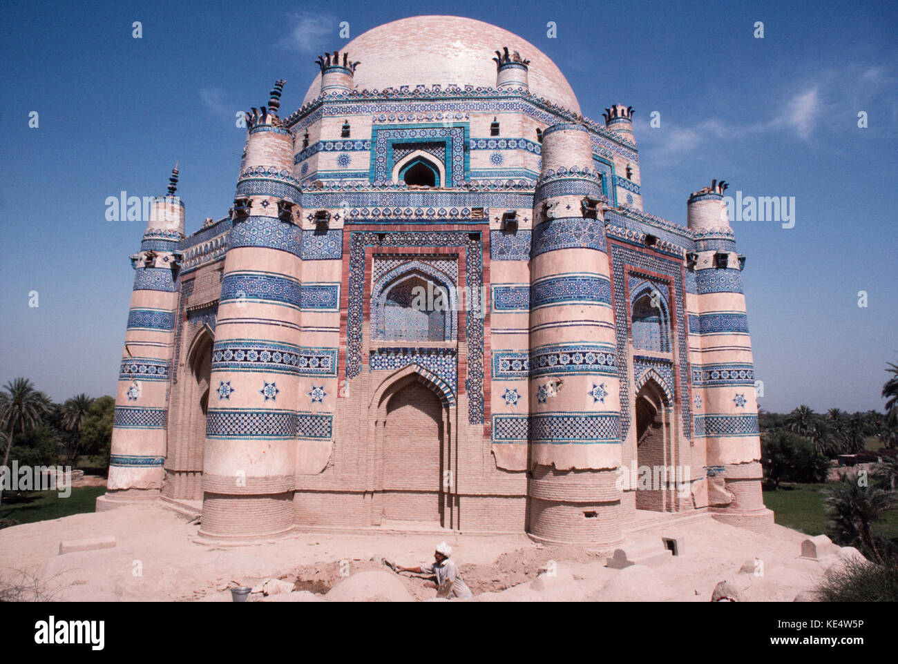 The Tomb of Bibi Jawindi at Uch. The man in the foregroung is digging a grave. Stock Photo