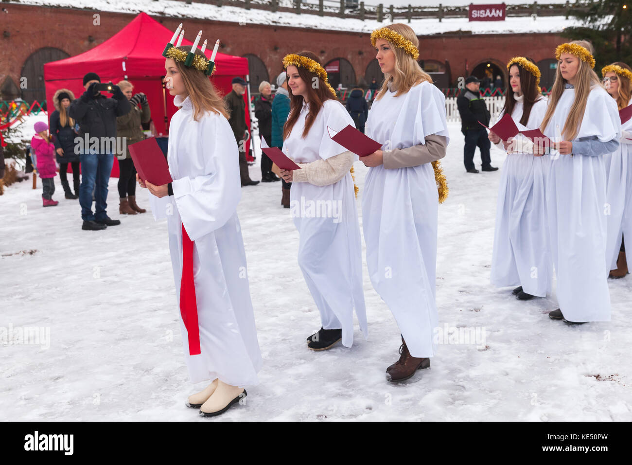 Hamina, Finland - December 13, 2014: choir of young Finnish girls goes to the Christmas fair Stock Photo
