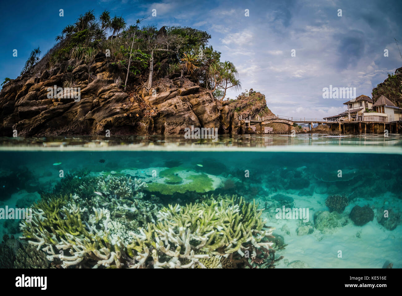 An over under image of Misool Eco Resort and its surrounding bay, Indonesia. Stock Photo